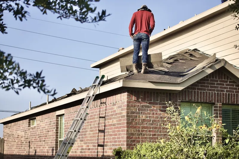 Professional roofer working on a residential roof in Castle Hill Estates